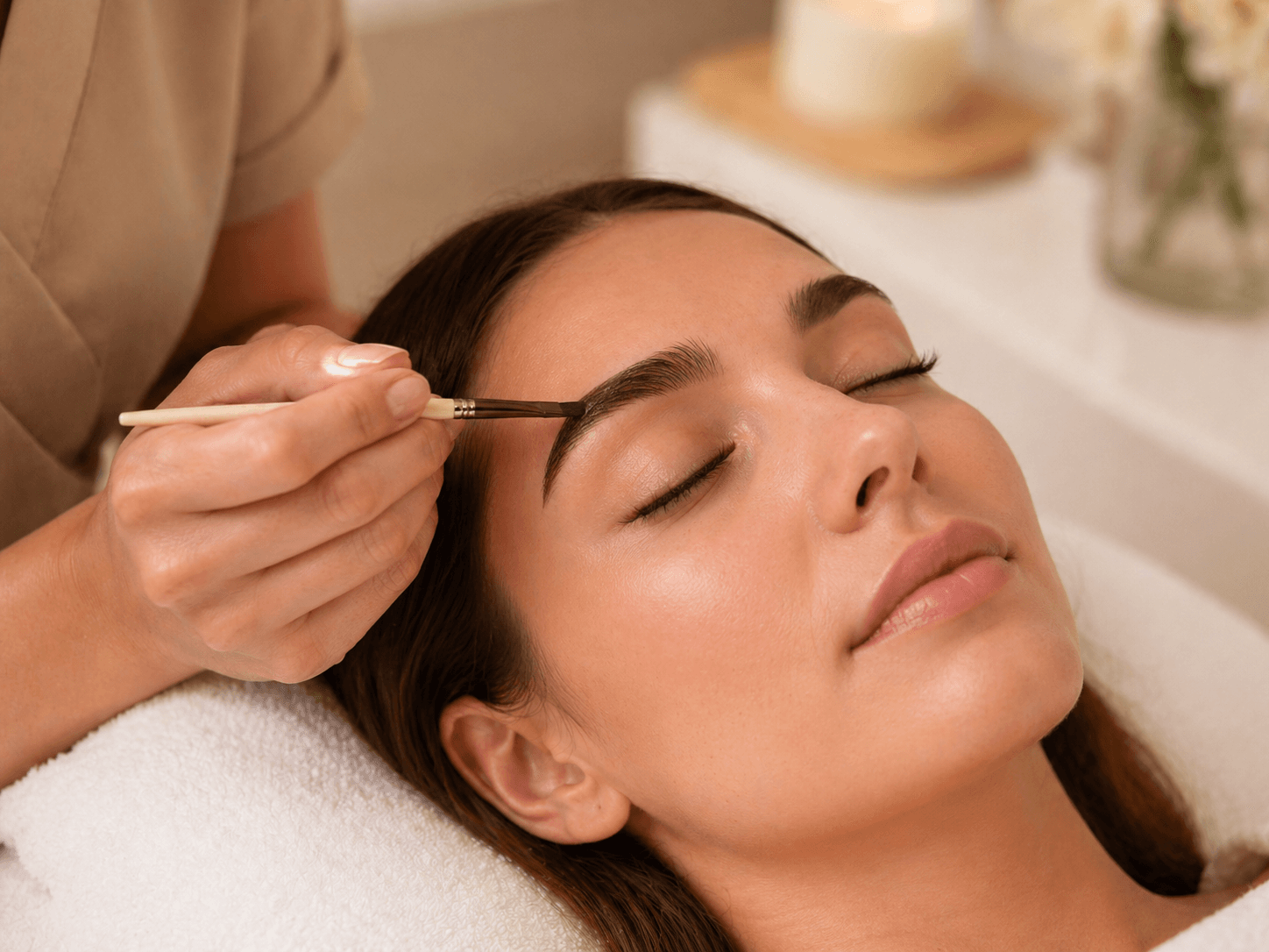Brow sculpting treatment being applied during an appointment.